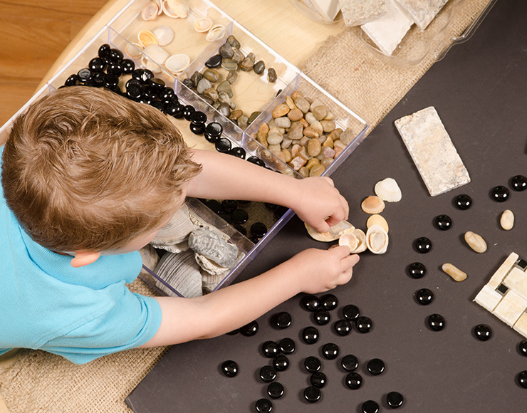 preschooler working with rocks